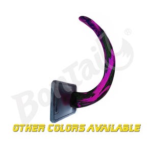 May include: A purple and black faux taxidermy tail wall mount. The tail is mounted on a black leather base. Other colors are available.