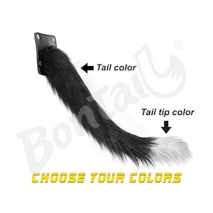 May include: A black and white faux fur tail with a leather attachment. The tail is black with a white tip. The text "CHOOSE YOUR COLORS" is displayed in yellow.