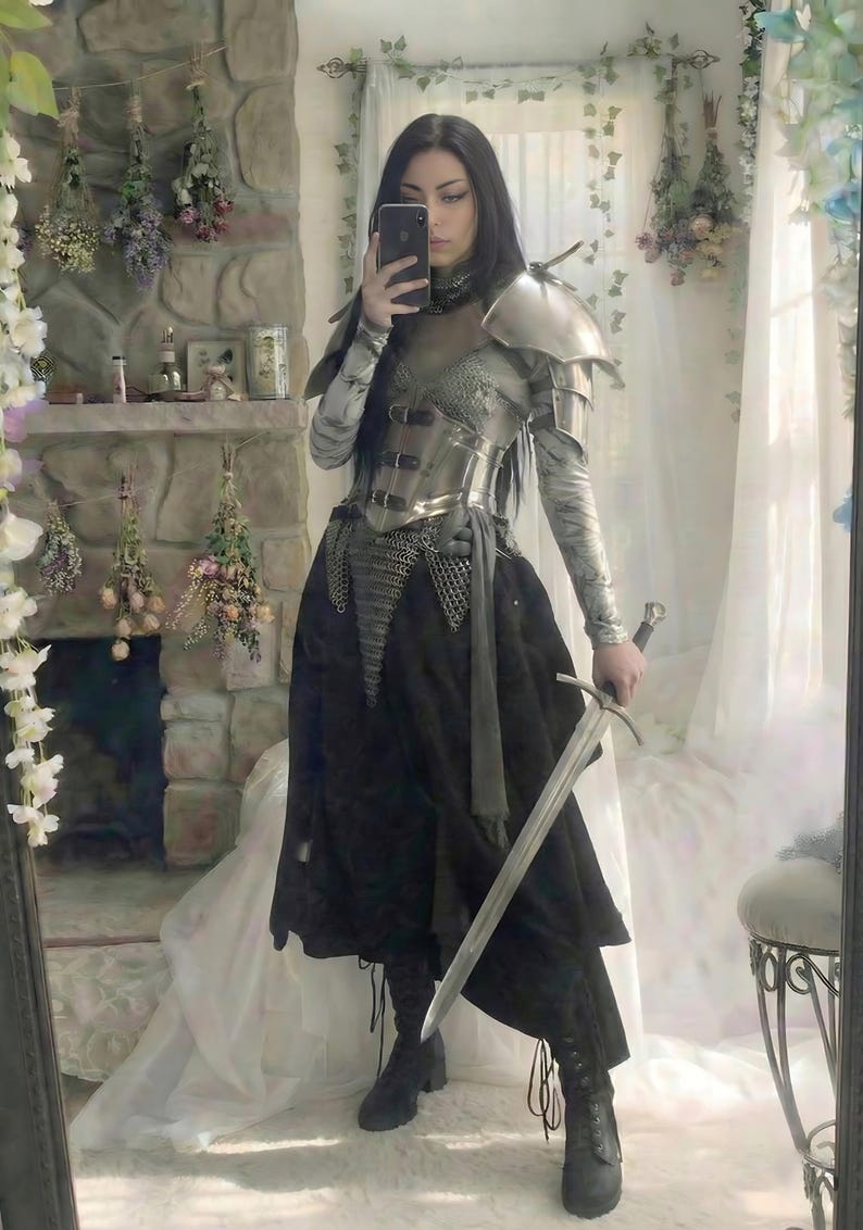 Female knight wearing steel corset armor with chainmail, pauldrons and bracers for Renaissance Faire fantasy cosplay
