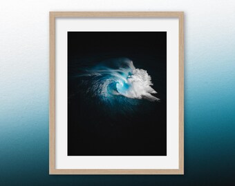 May include: A photograph of a large wave breaking in the ocean. The wave is backlit by the sun, creating a bright blue glow in the water. The wave is crashing against a dark background, creating a dramatic contrast.