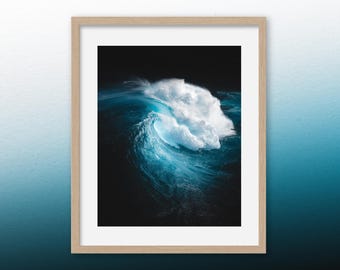 May include: A large wave crashes in the ocean, creating a swirling pattern of blue and white water against a dark background.