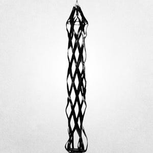 May include: A black, hanging, decorative object with a diamond-shaped lattice design. The object is suspended from a metal ring at the top and has a flared base. The design is symmetrical and appears to be made of a flexible material.