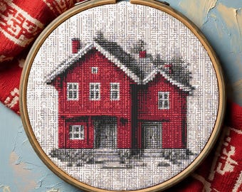 May include: A cross-stitch embroidery of a red house with a snow-covered roof and a wooden embroidery hoop. The house has multiple windows and a front porch. The background is a light gray and white pattern.