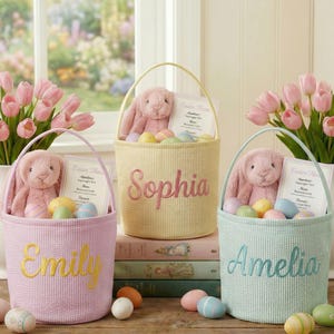 May include: Three Easter baskets in pastel colors, each with a plush bunny, decorative eggs, and a personalized name. Pink tulips in white vases flank the baskets, creating a festive spring scene.