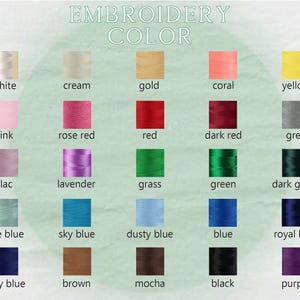 May include: An embroidery colour chart displaying a range of thread colours. The chart includes shades such as white, cream, gold, coral, yellow, pink, rose red, red, dark red, grey, lilac, lavender, grass, green, dark green, lake blue, sky blue, dusty blue, blue, royal blue, navy blue, brown, mocha, black, and purple.