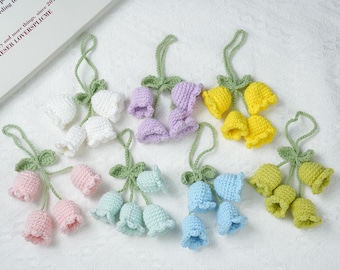 May include: A set of 10 crocheted flower charms in various colors, including pink, blue, green, yellow, and purple. Each charm features a cluster of small crocheted flowers with a loop for hanging.