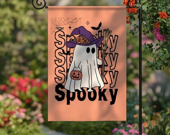 May include: A Halloween garden flag with a ghost wearing a witch hat and holding a pumpkin bucket. The flag has the word "Spooky" in black, with a spider web and bat graphic. The flag is peach-colored.