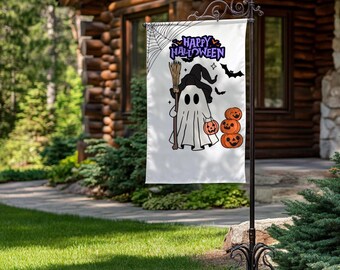 May include: A white Halloween garden flag featuring a cartoon ghost holding a broom and a pumpkin. The flag has the words "Happy Halloween" in purple and black, with a spider web and bats.