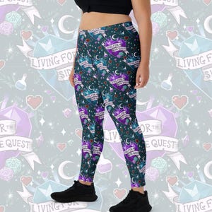 May include: Dark teal leggings with a repeating pattern of purple hearts, crowns, moons, and potion bottles. The leggings feature the text "LIVING FOR SIDE QUEST" on a banner. The background includes pixelated hearts, dice, and crystals.