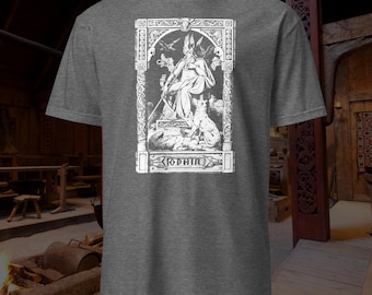 May include: Gray t-shirt featuring a white graphic of a seated figure with a staff, flanked by animals, and the word "ODHIN" below. The design is framed with ornate details, evoking a historical or mythological theme.