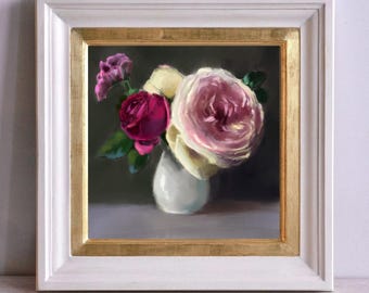 May include: A framed painting depicting a still life with a bouquet of pink, white and red roses in a white vase. The roses are arranged in a cluster, with the pink rose being the most prominent. The background is a dark grey.
