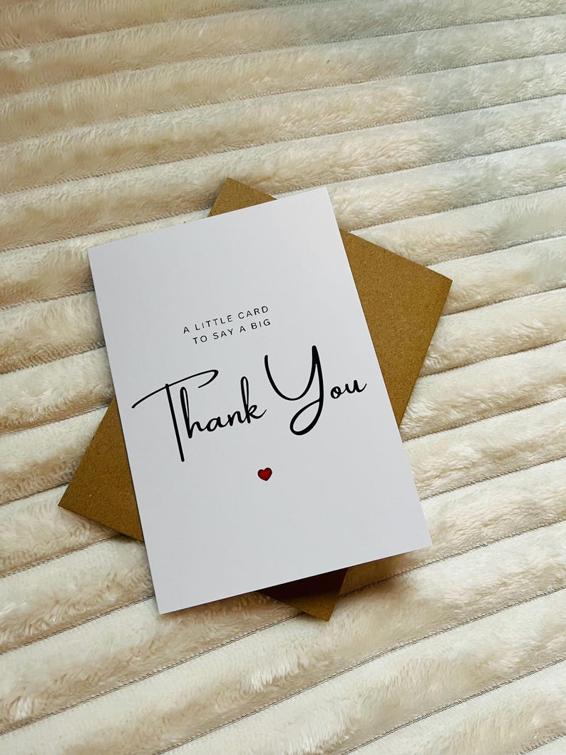 May include: A white card with a brown envelope. The card says "A little card to say a big Thank You" with a small red heart.