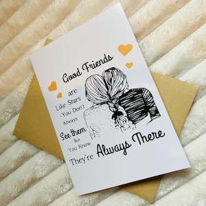 May include: A white card with black text and a black and white illustration of two women with their arms around each other. The text reads "Good Friends are Like Stars - You Don't Always See them But You Know They're Always There".