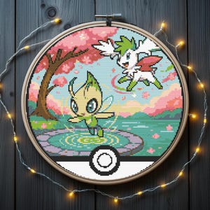 May include: Cross-stitch embroidery of two cartoon characters in a colorful landscape, framed in a wooden hoop. The scene includes a tree with pink blossoms, a pond, and a sky with pink and blue hues. The bottom half of the hoop is a white and black design.