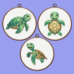 May include: Three embroidery hoops with different designs of green sea turtles. The turtles are all in a cartoon style and have brown shells.