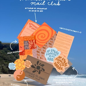 May include: A collection of stationery items including a brown envelope with a sun logo, orange patterned papers, and several stickers with the text "MI LUGAR FAVORITO ES EL AHORA". The items are labeled with text including "REMEMBER THE MAGIC MAIL CLUB".