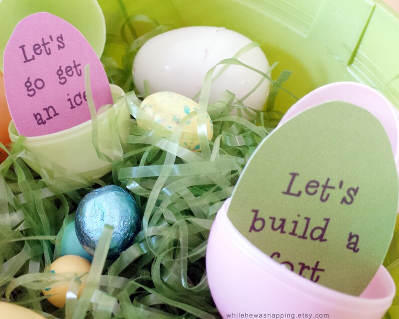 May include: Pink and green plastic Easter eggs with paper inserts that read "Let's go get an ice cream" and "Let's build a fort". The eggs are nestled in green shredded paper.
