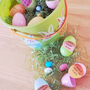May include: A green bucket filled with plastic Easter eggs, some with paper notes inside. The notes say "Let's go get an ice cream", "Let's build a", "Let's make some", "Let's go ride bikes", and "cream sundaes with".