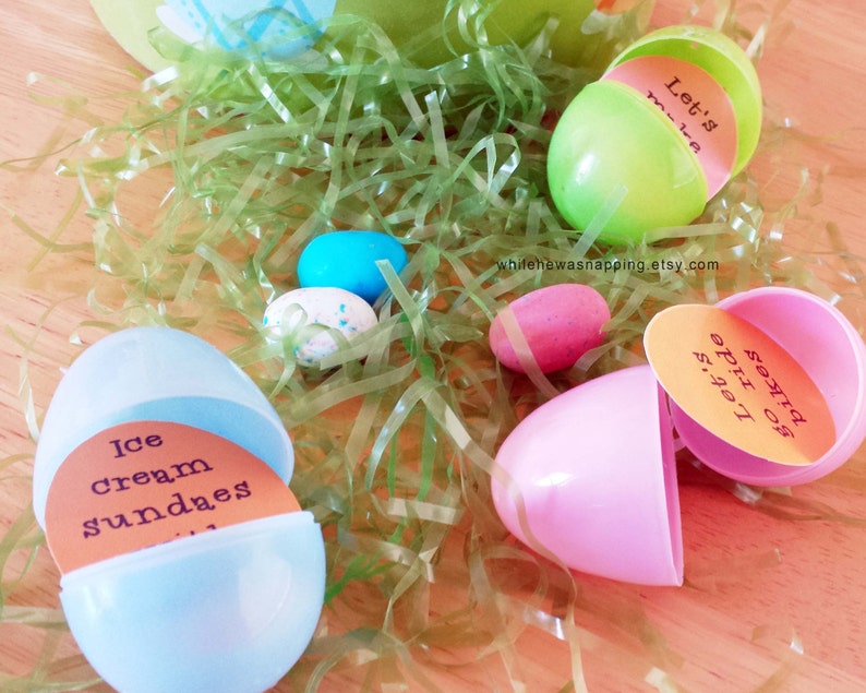 May include: Plastic Easter eggs with different messages inside. The messages include "Let's go ride", "Let's make", "Ice cream sundaes", and "Let's go pizza". The eggs are sitting on a bed of green grass.
