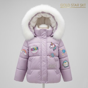 May include: A lilac puffer jacket with a white faux fur hood. The jacket is decorated with colourful embroidered patches including a rainbow, unicorn, planets, and an astronaut cat. The text "Chloe" and "Luna" are also visible on the jacket.