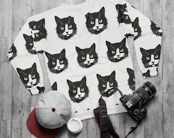 May include: White sweatshirt with a black and white cat pattern. The cat faces are repeated throughout the sweatshirt.