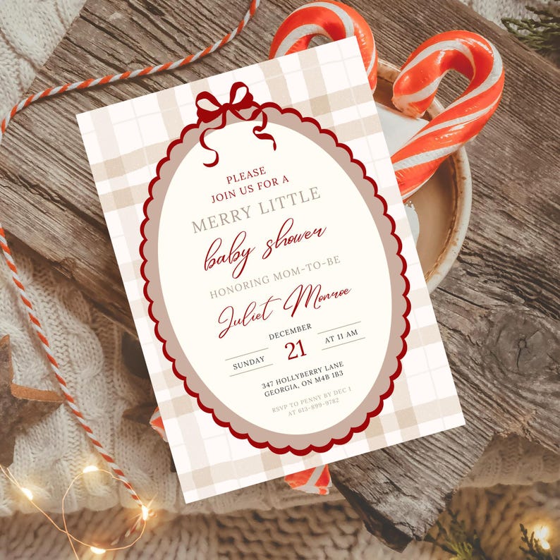 May include: A baby shower invitation with a cream-colored oval frame and a red bow at the top. The invitation has a plaid background and includes the text "MERRY LITTLE baby shower" and details for Juliet Monroe's baby shower.