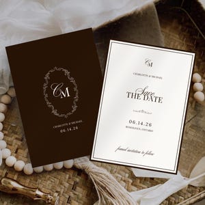 May include: Two wedding invitation cards. One is dark brown with a white floral design and the initials "CM". The other is white with the text "Save the Date" and the date "06.14.26".