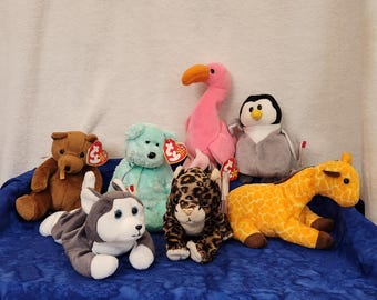 Beanie Baby Sherwood Bear Nanook the Husky Green Sherbet Bear Pinky the Flamingo Sneaky the Jager Slapshot the Penguin or Twigs the Giraffe