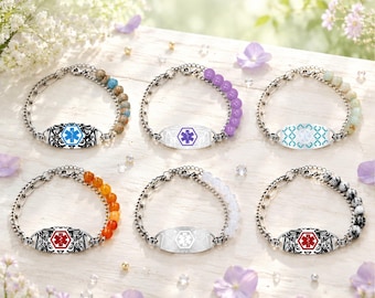 May include: Six medical alert bracelets featuring silver-tone metal chains and central identification plates. Each plate displays a Star of Life symbol in various colors, accompanied by segments of colorful beads including earth tones, purple, and white.
