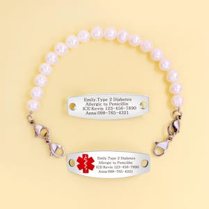 May include: A pearl beaded medical ID bracelet with a silver tag. The tag has the following text: Emily, Type 2 Diabetes, Allergic to Penicillin, ICE: Kevin 123-456-7890, Anna: 098-765-4321. A red medical symbol is on the tag.