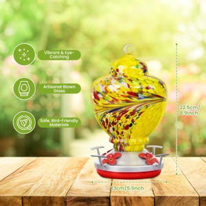 May include: A hummingbird feeder with a yellow, red, and blue speckled glass reservoir, a silver base, and red flower-shaped feeding ports. The feeder measures 8.9 inches in height and 5.1 inches in width, featuring text labels for product features.