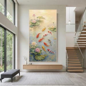 May include: A large vertical wall art painting depicting a pond with multiple koi fish in shades of orange, red, white, and yellow swimming among green lily pads and blooming pink and white lotus flowers on a soft, light-colored water surface.