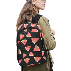May include: Black backpack with a watermelon print. The backpack has a zipper closure and adjustable straps.