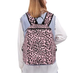 Sac à dos rose à imprimé léopard - Cartable léger et décontracté pour femme et adolescente, sac d'école élégant à imprimé animal, sac à dos entièrement imprimé