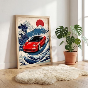 May include: A framed art print featuring a red sports car racing through stylized ocean waves, with a red sun and a mountain in the background. The artwork is in a Japanese Ukiyo-e style, with a wooden frame.