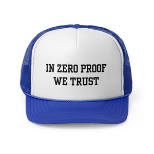 May include: A white trucker hat with a blue mesh back. The hat has black text that reads "IN ZERO PROOF WE TRUST".