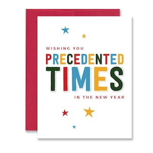 Funny New Year greeting card reading “Wishing You Precedented Times in the New Year” in colorful text with stars surrounding text. Paired with a red envelope.