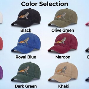 May include: A collection of baseball caps in various colors, including white, black, olive green, pink, red, royal blue, maroon, charcoal gray, purple, dark green, khaki, and navy. Each cap features an embroidered design.