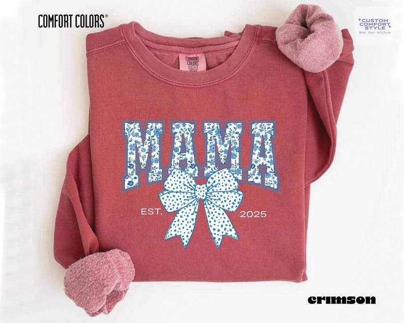 Elevate your style with this Custom Comfort Colors Mama Est Sweatshirt, a perfect blend of comfort and elegance. Designed with a Chinoiserie Blue Toile De Jouy pattern, this Coquette Bow Sweatshirt brings a timeless and feminine touch to any outfit. Whether you're looking for a girly aesthetic crewneck or a unique Mother's Day Gift, this Comfort Colors 1566 sweatshirt is a stylish and meaningful choice for moms.
Featuring a blue ribbon sweater design, this ribbon sweatshirt is inspired
