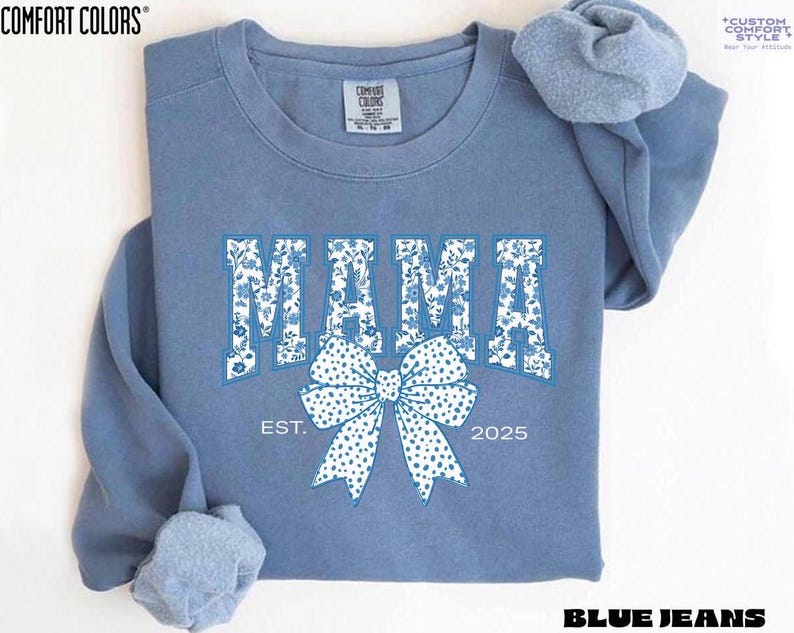 Elevate your style with this Custom Comfort Colors Mama Est Sweatshirt, a perfect blend of comfort and elegance. Designed with a Chinoiserie Blue Toile De Jouy pattern, this Coquette Bow Sweatshirt brings a timeless and feminine touch to any outfit. Whether you're looking for a girly aesthetic crewneck or a unique Mother's Day Gift, this Comfort Colors 1566 sweatshirt is a stylish and meaningful choice for moms.
Featuring a blue ribbon sweater design, this ribbon sweatshirt is inspired