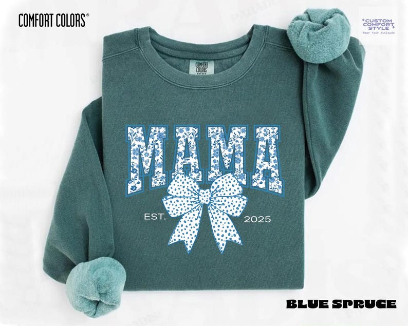 Elevate your style with this Custom Comfort Colors Mama Est Sweatshirt, a perfect blend of comfort and elegance. Designed with a Chinoiserie Blue Toile De Jouy pattern, this Coquette Bow Sweatshirt brings a timeless and feminine touch to any outfit. Whether you're looking for a girly aesthetic crewneck or a unique Mother's Day Gift, this Comfort Colors 1566 sweatshirt is a stylish and meaningful choice for moms.
Featuring a blue ribbon sweater design, this ribbon sweatshirt is inspired