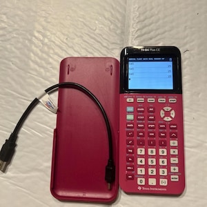 May include: A pink TI-84 Plus CE graphing calculator with its matching cover and a black USB cable. The calculator's screen displays numbers. The Texas Instruments logo is visible.