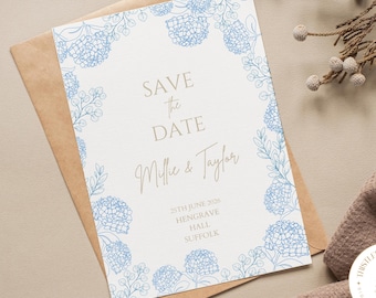 May include: A blue and white save the date card with a floral border. The text reads "Save the Date" with the names "Mille & Taylor" and the date "25th June 2020". The location is listed as "Hengrave Hall, Suffolk".