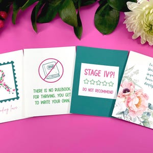 May include: Four greeting cards with various designs and text. One card features a ribbon made of hearts, another says "THERE IS NO RULEBOOK FOR THRIVING. YOU GET TO WRITE YOUR OWN." A third card reads "STAGE IV?! DO NOT RECOMMEND." The last card has floral art and says "For the days thriving seems impossible, know you are deeply loved."