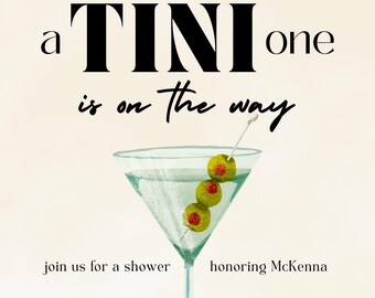 May include: A watercolour illustration of a martini glass with green olives. The text "a TINI one is on the way" is at the top of the image. The text "SATURDAY AUG 15 3:30-5 PM" is at the bottom of the image. The text "join us for a shower honouring McKenna" is in the middle of the image. The text "registered at Target and Amazon rsvp to Amy 954-555-5555" is at the bottom of the image.