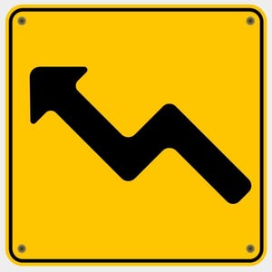 May include: A yellow road sign featuring a black arrow indicating a winding road ahead, pointing left and downwards. The sign has a black border and is secured with four rivets.