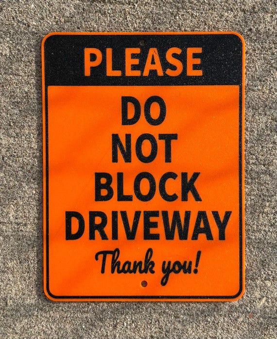 Do Not Block Driveway Sign in Vibrant Orange With Black Lettering