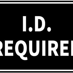May include: A rectangular black sign with white text that reads "I.D. REQUIRED." The sign has a white border and is secured with four silver rivets. The sign is designed to be easily readable.
