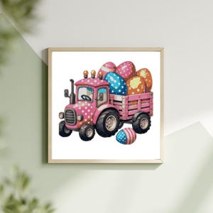 May include: A framed watercolour print of a pink tractor with white polka dots, carrying a load of colourful Easter eggs. The eggs are decorated with various patterns and colours, including pink, blue, and orange. One egg is separate from the tractor.