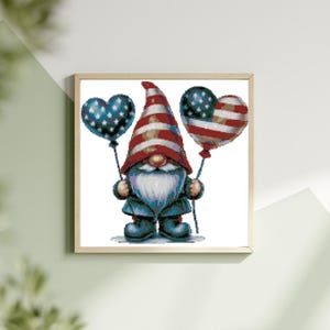 May include: A gnome wearing a red, white, and blue hat holds two heart-shaped balloons with an American flag design.